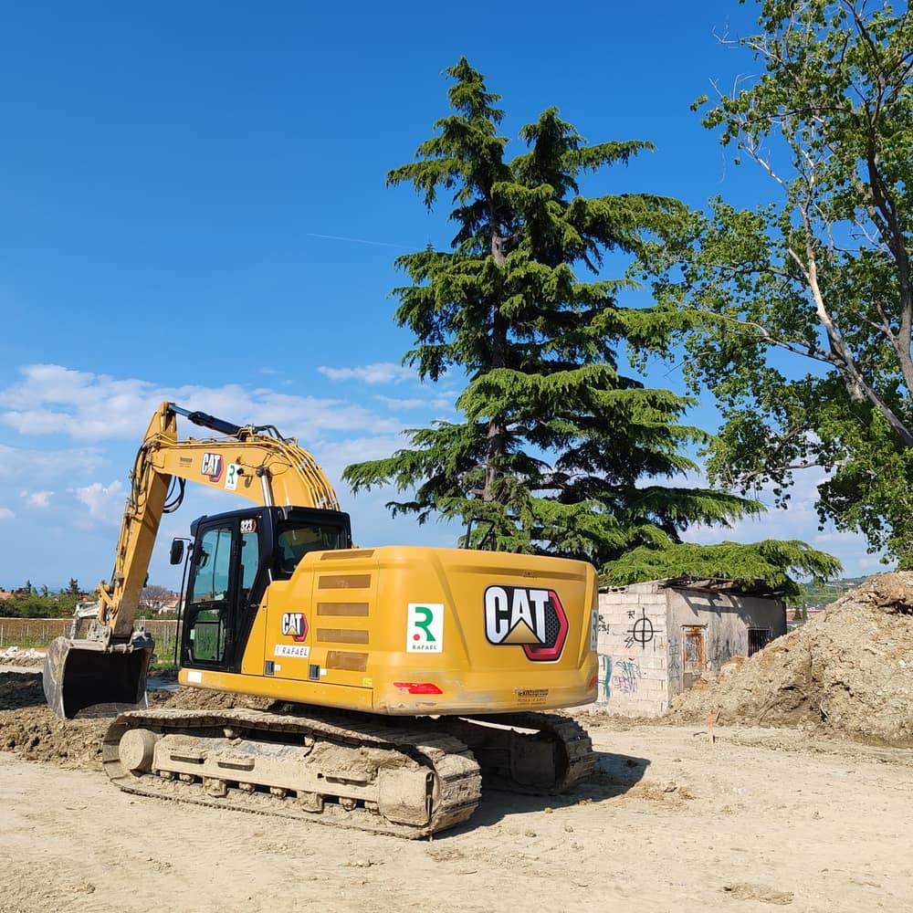 An excavator digging on an open site